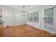 Bright dining area with hardwood floors, wainscoting, and a view to the backyard at 8805 Deerland Ct, Huntersville, NC 28078