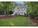 Charming two-story traditional home with a manicured front lawn and mature trees offers great curb appeal at 8805 Deerland Ct, Huntersville, NC 28078