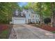Traditional two-story home featuring a two-car garage and well-maintained landscaping adds to its appeal at 8805 Deerland Ct, Huntersville, NC 28078