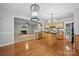 Open-concept kitchen with wood floors, granite countertops, and an island flows into the living room at 8805 Deerland Ct, Huntersville, NC 28078