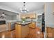 Open concept kitchen with wood floors, center island, and stainless steel appliances at 8805 Deerland Ct, Huntersville, NC 28078