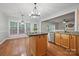 Eat-in kitchen features wood floors, a center island, stainless appliances, and lots of natural light at 8805 Deerland Ct, Huntersville, NC 28078
