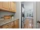 Bright kitchen with granite counters, stainless fridge and stainless appliances overlooking breakfast area at 8805 Deerland Ct, Huntersville, NC 28078