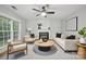 Bright living room with fireplace, white sofa, and ample seating at 8805 Deerland Ct, Huntersville, NC 28078