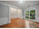 Inviting living room featuring beautiful hardwood floors, wainscoting, and ample natural light at 8805 Deerland Ct, Huntersville, NC 28078