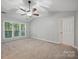 Spacious main bedroom with vaulted ceilings, neutral carpet, large window with lots of light and ceiling fan at 8805 Deerland Ct, Huntersville, NC 28078