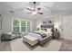 Well-staged main bedroom with sitting area, bed, lamps, and bedside tables at 8805 Deerland Ct, Huntersville, NC 28078