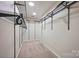 Walk-in closet with carpeted floor, recessed lighting, and metal shelving system and hanging rods at 8805 Deerland Ct, Huntersville, NC 28078