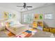 Bright bedroom features lots of natural light, ceiling fan, and a closet at 8915 Merrie Rose Ave, Charlotte, NC 28213