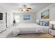 Spacious primary bedroom features a ceiling fan, large window and decor to create a serene atmosphere at 8915 Merrie Rose Ave, Charlotte, NC 28213