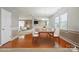 Bright dining area with hardwood floors, contemporary lighting, and an open flow to the connected living spaces at 8915 Merrie Rose Ave, Charlotte, NC 28213