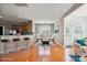 Open floor plan dining area features hardwood floors, a kitchen bar, and lots of natural light at 8915 Merrie Rose Ave, Charlotte, NC 28213