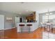 Eat-in kitchen features hardwood floors, breakfast bar, stainless appliances, and adjacent dining area at 8915 Merrie Rose Ave, Charlotte, NC 28213
