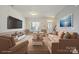 Inviting living room with neutral paint, light carpet, plenty of seating, and a mounted flatscreen television at 8915 Merrie Rose Ave, Charlotte, NC 28213