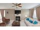 Cozy living room features a fireplace, ceiling fan, and comfortable seating for a relaxing atmosphere at 8915 Merrie Rose Ave, Charlotte, NC 28213
