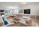 Open concept design seamlessly blends the living and dining spaces with neutral colors and modern decor at 8915 Merrie Rose Ave, Charlotte, NC 28213