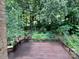 Spacious back deck overlooking a lush, green, wooded yard, perfect for outdoor relaxation at 9305 Harps Mill Ct, Charlotte, NC 28270