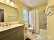 This bathroom features a double vanity and a shower-tub combo at 9305 Harps Mill Ct, Charlotte, NC 28270