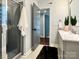 Modern bathroom featuring a glass shower, sleek gray vanity, and stylish neutral-toned decor at 9305 Harps Mill Ct, Charlotte, NC 28270