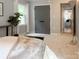 Bright bedroom with a leafy indoor plant, soft carpet, and natural light from the nearby window at 9305 Harps Mill Ct, Charlotte, NC 28270