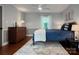Bright bedroom showcasing wood floors, natural light, neutral walls, and stylish décor at 9305 Harps Mill Ct, Charlotte, NC 28270