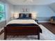 Well-lit bedroom with stylish décor, featuring a dark wood bed and soft natural light at 9305 Harps Mill Ct, Charlotte, NC 28270