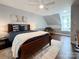 Comfortable bedroom with a dark wood bed, white rug, and soft natural light at 9305 Harps Mill Ct, Charlotte, NC 28270