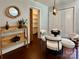 Dining area showcasing wood floors, a round glass table, and a glimpse into a pantry at 9305 Harps Mill Ct, Charlotte, NC 28270