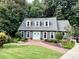 Beautiful home exterior with well-kept landscaping, a brick walkway, and a charming, light-blue front door at 9305 Harps Mill Ct, Charlotte, NC 28270