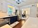 Well-lit kitchen featuring stainless appliances and hardwood floors opens to dining room at 9305 Harps Mill Ct, Charlotte, NC 28270
