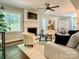 Cozy living room featuring a white-brick fireplace, modern furnishings, and a ceiling fan at 9305 Harps Mill Ct, Charlotte, NC 28270