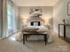Serene main bedroom boasts neutral color palette, soft lighting, and plush carpeting at 9305 Harps Mill Ct, Charlotte, NC 28270