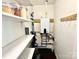 Organized pantry with shelving, storage for kitchen essentials, and water heater at 9305 Harps Mill Ct, Charlotte, NC 28270