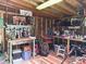 Well-lit work shed featuring wooden walls, storage, and peg boards for tools at 9305 Harps Mill Ct, Charlotte, NC 28270