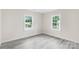 Bright bedroom features two windows and gray wood-look flooring at 1017 W Fisher St, Salisbury, NC 28144