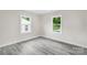 Bedroom featuring two windows and gray wood-look flooring at 1017 W Fisher St, Salisbury, NC 28144