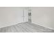 Bright bedroom features an open doorway and gray wood-look flooring at 1017 W Fisher St, Salisbury, NC 28144