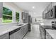 Modern kitchen with gray cabinets, stainless steel appliances, and white countertops at 1017 W Fisher St, Salisbury, NC 28144