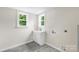 Bright laundry room with a new sink, cabinets, and washer/dryer hookups at 1017 W Fisher St, Salisbury, NC 28144
