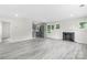 Open floor plan with gray floors, a fireplace, and stainless steel kitchen appliances at 1017 W Fisher St, Salisbury, NC 28144
