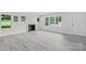 Bright living room featuring new gray flooring, a fireplace, and large windows at 1017 W Fisher St, Salisbury, NC 28144