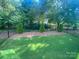 Well-maintained backyard featuring a black metal fence and green lawn at 10416 Audubon Ridge Dr # 4, Cornelius, NC 28031
