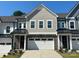 Charming townhome featuring stone accents, a two-car garage, and professionally landscaped front yard at 10416 Audubon Ridge Dr # 4, Cornelius, NC 28031