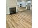Open concept view of the kitchen and fireplace with modern flooring at 10416 Audubon Ridge Dr # 4, Cornelius, NC 28031