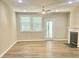 Bright living room with fireplace, ceiling fan, and ample windows at 10416 Audubon Ridge Dr # 4, Cornelius, NC 28031