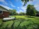 Side view of a large backyard with mature trees showcasing outdoor space and potential at 1050 Old Peachland Rd, Marshville, NC 28103