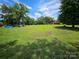 Expansive backyard with mature trees and ample green space perfect for outdoor activities at 1050 Old Peachland Rd, Marshville, NC 28103