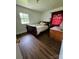 Cozy bedroom featuring comfortable decor, window providing natural light and hardwood floors at 1050 Old Peachland Rd, Marshville, NC 28103