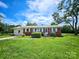 Traditional brick home featuring a cozy front yard in a serene neighborhood at 1050 Old Peachland Rd, Marshville, NC 28103