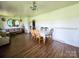 Open-concept living and dining area with wood flooring, providing ample space for entertaining at 1050 Old Peachland Rd, Marshville, NC 28103